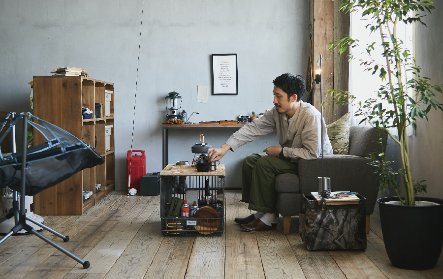 好きなものに囲まれてソファでくつろぐ男性の写真